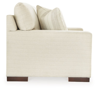 Ashley Furniture Maggie Loveseat with plush fabric and cushioned arms, perfect for comfortable seating in living rooms.