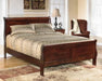 Ashley Furniture Alisdair Bed with a sturdy wooden frame and stylish design, shown in a cozy bedroom setting.