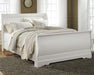 Ashley Furniture Anarasia Bed with elegant headboard and wooden frame, showcased in a modern bedroom setting.