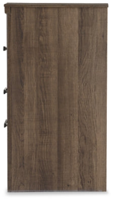 Ashley Furniture Juararo nightstand with a modern design, featuring a dark wood finish and sleek hardware on a bedroom side table.