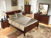 Ashley Furniture Alisdair Bed with dark wood finish and elegant headboard, showcasing a stylish and sturdy bedroom centerpiece.