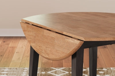 Ashley Furniture Gesthaven dining room set with a round table and six upholstered chairs, featuring elegant wood detailing.