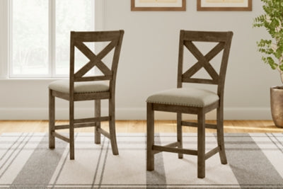 Ashley Furniture Moriville counter height dining set with wooden table and four matching chairs in a warm finish.