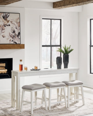 Ashley Furniture Robbinsdale counter height dining table with three matching barstools, showcasing a modern wood finish and sturdy design.