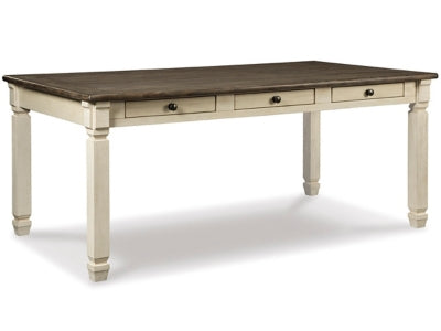 Ashley Furniture Bolanburg dining table with a wooden finish, rectangular shape, and sturdy legs in a spacious dining room setting.