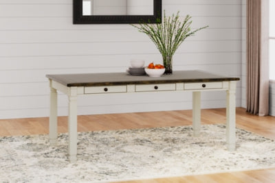 Ashley Furniture Bolanburg dining room set with a table and six chairs in a warm wooden finish, shown in a well-lit dining space