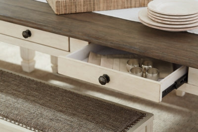 Close-up of Ashley Furniture Bolanburg dining table showcasing its wood finish and detailed craftsmanship.