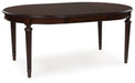 Ashley Furniture Lavinton dining room set with a table, leaf extension, and matching chairs, shown from an angled view.
