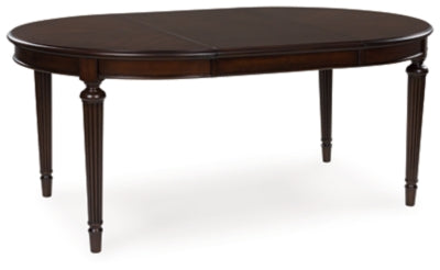Ashley Furniture Lavinton dining room set with a table, leaf extension, and matching chairs, shown from an angled view.