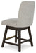 Elegant Ashley Furniture dining room set with a large table and matching chairs, viewed from an angled back perspective.