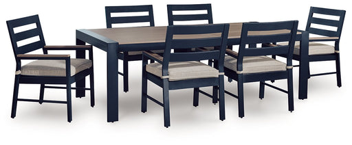 East Beach outdoor dining set by Ashley Furniture with a glass-top table and six matching chairs in a garden setting.