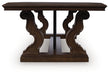 Ashley Furniture Maylee coffee table, cocktail table with a sleek wooden finish and modern design, shown from a side view.