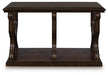 Ashley Furniture Maylee Sofa Table with sleek wood finish, featuring a rectangular top and sturdy legs, shown from a front head-on view.
