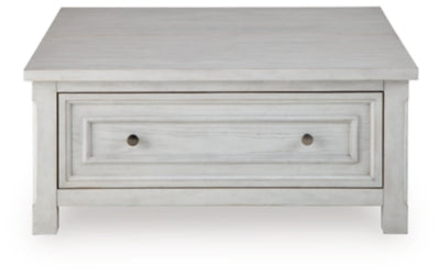 Ashley Furniture Robbinsdale lift-top coffee table with a sleek wooden surface and open storage in a modern living room setting.